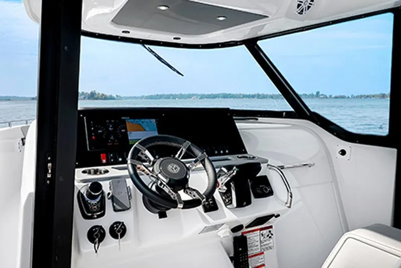 Slide: The Image of 2026 Cruisers Yachts 38 VTR helm with modern controls and scenic water view. - 5