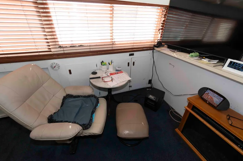 Slide: The Image of Interior of a 1974 Bertram 46.6 yacht with cozy seating and modern amenities. - 15