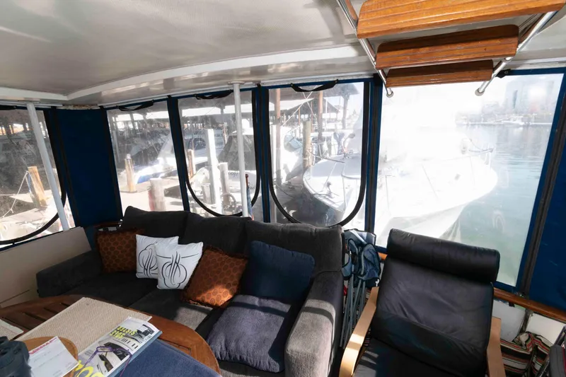 Slide: The Image of Interior of a 1974 Bertram 46.6 yacht with cozy seating and marina view. - 2