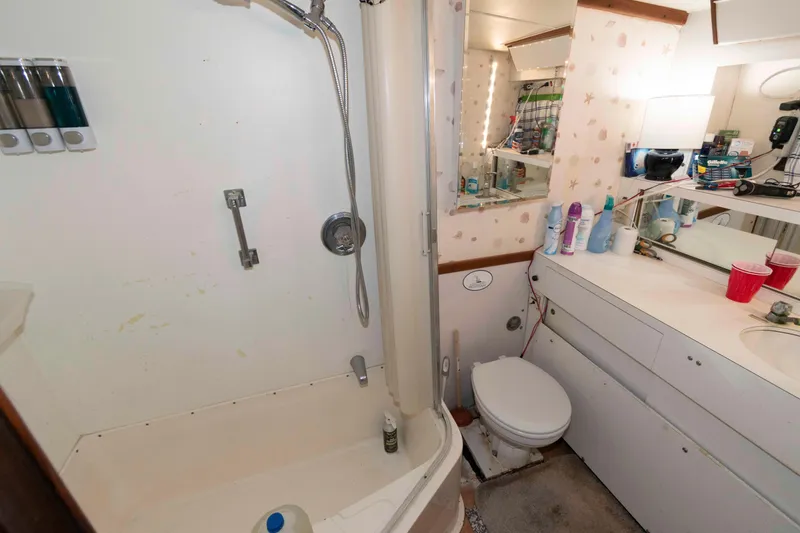 Slide: The Image of Bathroom interior of a 1974 Bertram 46.6 yacht with shower and vanity area. - 20