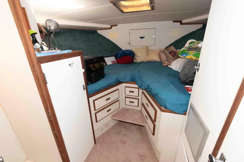 Slide: The Image of 1974 Bertram 46.6 boat cabin interior with bed, storage, and cozy decor. - 21