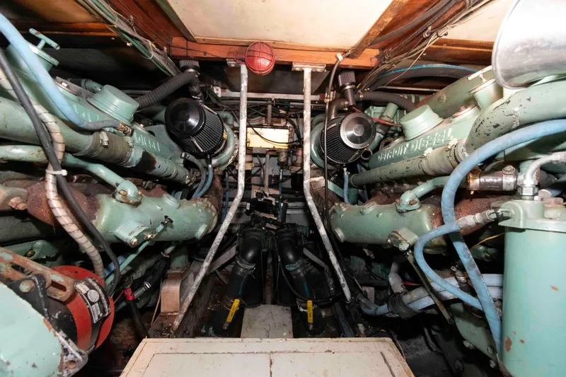 Slide: The Image of Engine room of a 1974 Bertram 46.6 yacht with twin diesel engines. - 24
