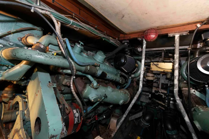 Slide: The Image of Engine room of a 1974 Bertram 46.6 yacht, showcasing vintage machinery and components. - 25