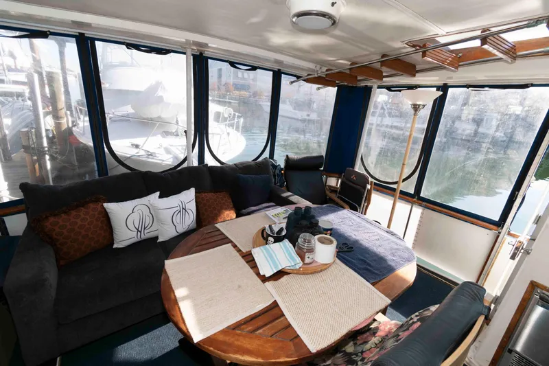 Slide: The Image of Interior of a 1974 Bertram 46.6 yacht with cozy seating and dining area. - 3