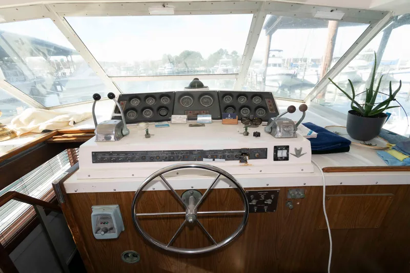 Slide: The Image of 1974 Bertram 46.6 yacht helm with steering wheel, gauges, and controls. - 4