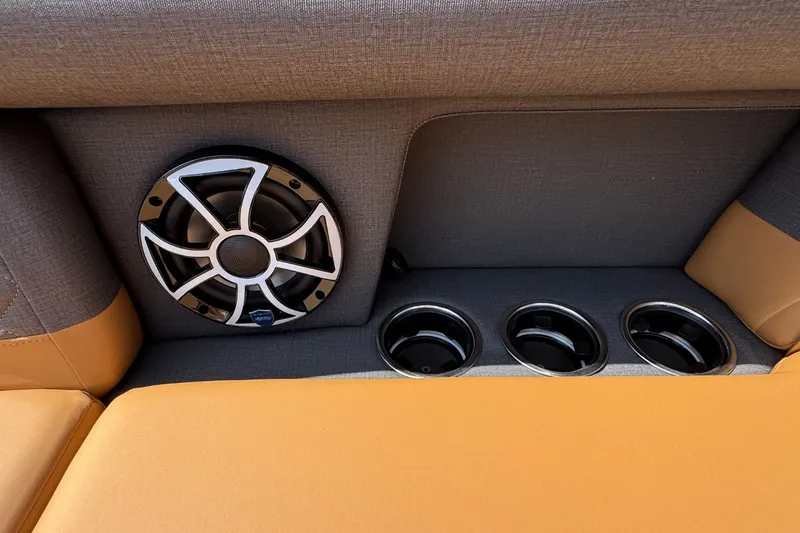 Slide: The Image of Close-up of a speaker and cup holders on a boat with orange upholstery. - 23