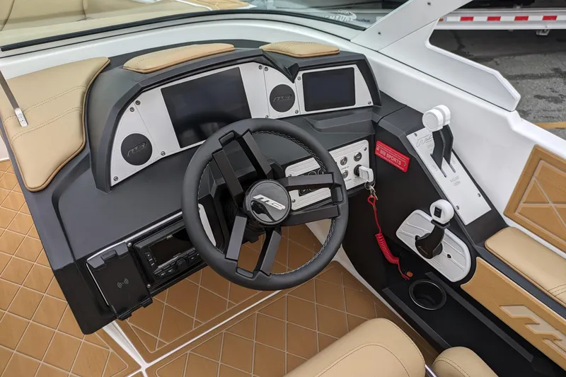 Slide: The Image of 2026 MB F22 Tomcat Alpha boat dashboard with modern controls and tan seating. - 4