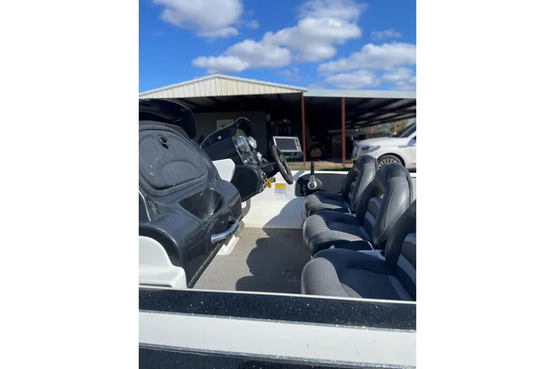 Slide: The Image of 2010 Nitro Z-7 boat interior with steering wheel and seats under blue sky. - 4
