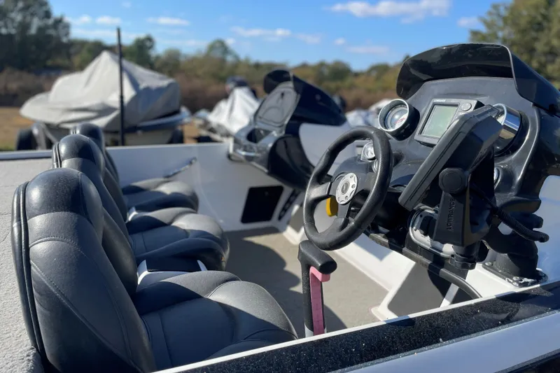 Slide: The Image of 2010 Nitro Z-7 boat interior with steering wheel and seats in outdoor setting. - 6