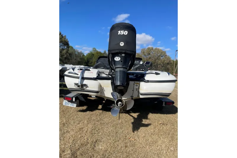 Slide: The Image of 2010 Nitro Z-7 boat with 150 HP engine on grassy field. - 7