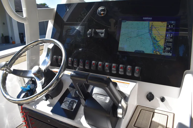 Slide: The Image of 2023 Yamaha Boats 252 FSH Sport interior, featuring helm and seating area. - 12