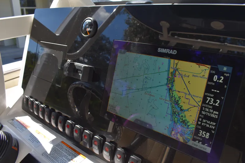 Slide: The Image of 2023 Yamaha Boats 252 FSH Sport center console, displayed at a boat dealership. - 13