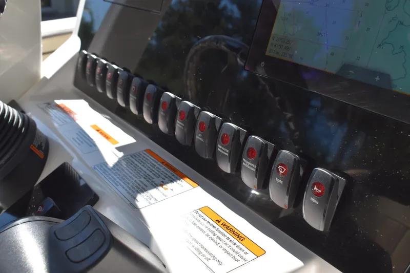 Slide: The Image of 2023 Yamaha Boats 252 FSH Sport center console view at a boat dealership. - 14