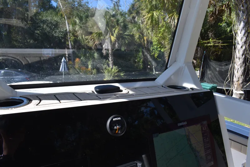 Slide: The Image of 2023 Yamaha Boats 252 FSH Sport dashboard with steering wheel and navigation display. - 16