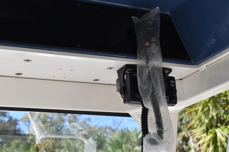 Slide: The Image of Control panel of 2023 Yamaha Boats 252 FSH Sport with various light switches and warning labels. - 18