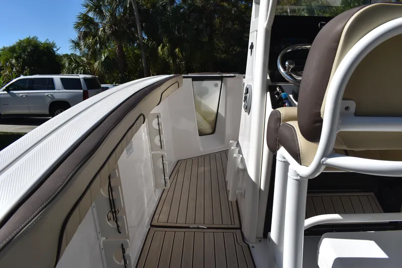 Slide: The Image of 2023 Yamaha Boats 252 FSH Sport dashboard with steering wheel and navigation display. - 20