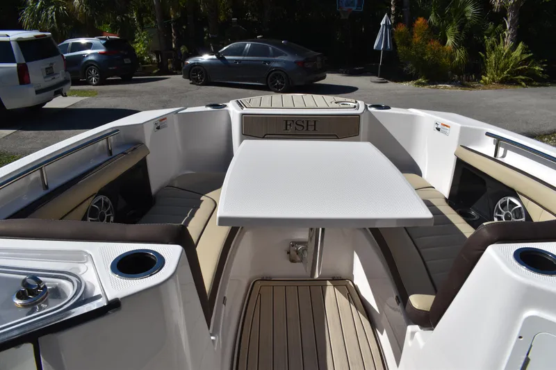 Slide: The Image of 2023 Yamaha Boats 252 FSH Sport interior view with electronics and storage compartment. - 22