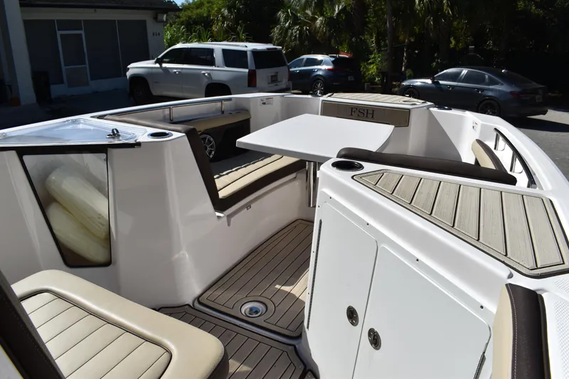 Slide: The Image of Interior view of 2023 Yamaha Boats 252 FSH Sport, featuring dashboard and navigation equipment. - 24