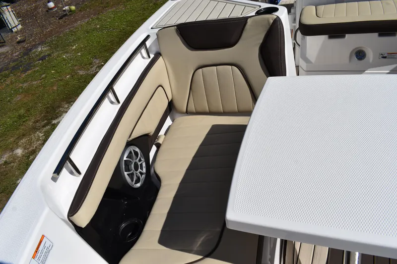 Slide: The Image of 2023 Yamaha Boats 252 FSH Sport at a dealership, surrounded by other boats and vehicles. - 25