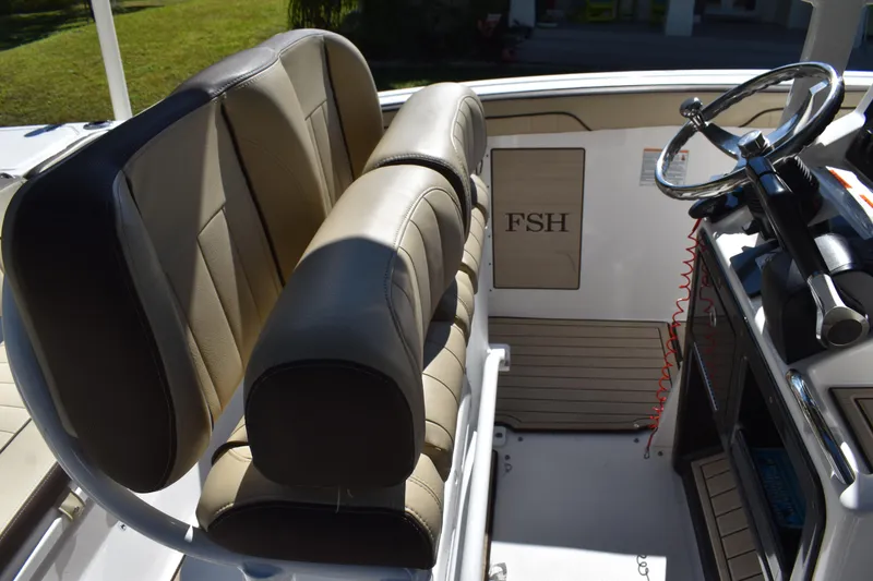 Slide: The Image of 2023 Yamaha Boats 252 FSH Sport storage compartment with tackle boxes and bins. - 28