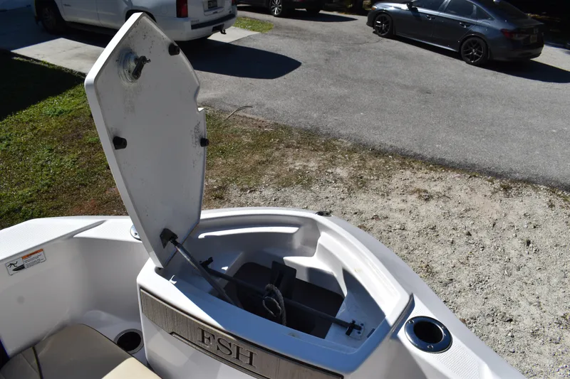 Slide: The Image of 2023 Yamaha Boats 252 FSH Sport anchor compartment with rope and hardware. - 35