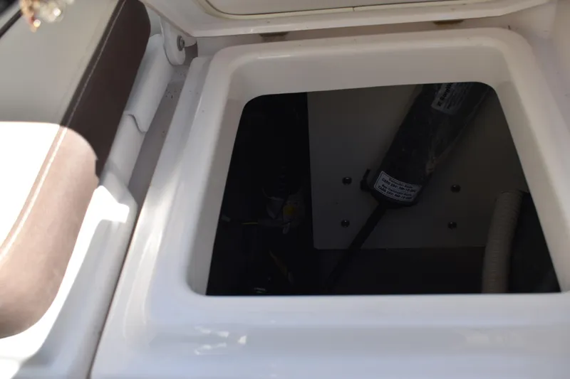 Slide: The Image of 2023 Yamaha Boats 252 FSH Sport storage compartment open on deck. - 44