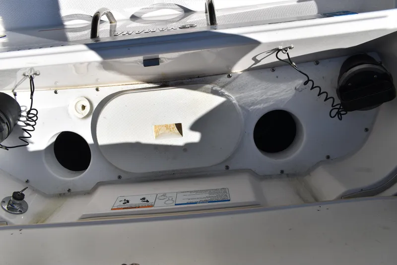 Slide: The Image of 2023 Yamaha Boats 252 FSH Sport open storage compartment on deck. - 48