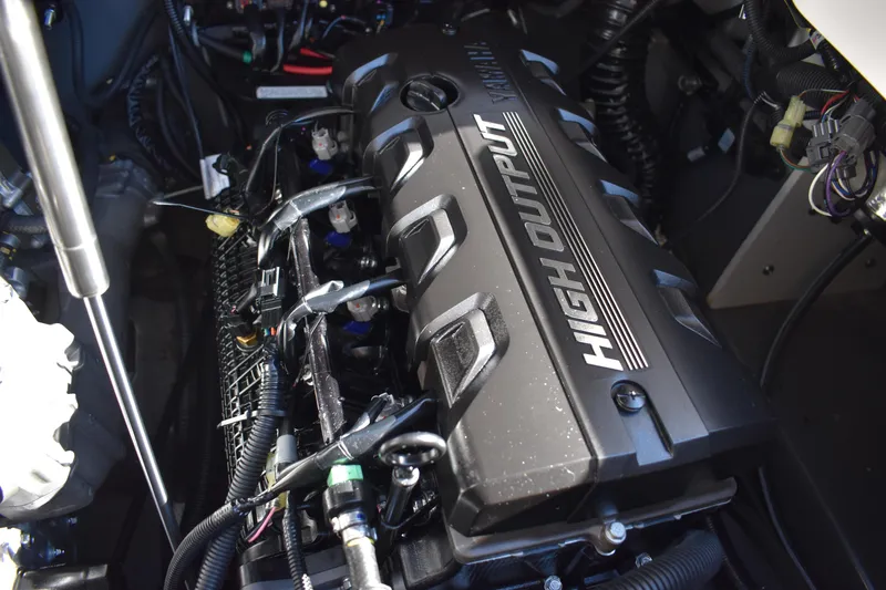 Slide: The Image of 2023 Yamaha Boats 252 FSH Sport interior view, showcasing seating and storage compartments. - 52