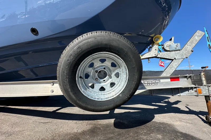 Slide: The Image of 2023 Yamaha Boats 252 FSH Sport on trailer, featuring Load Star tire. - 58