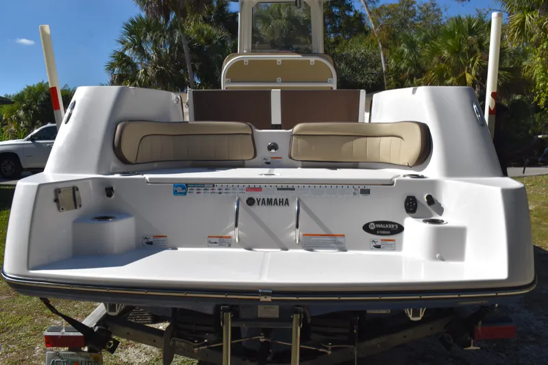 Slide: The Image of 2023 Yamaha Boats 252 FSH Sport on trailer, showcasing sleek hull design. - 8