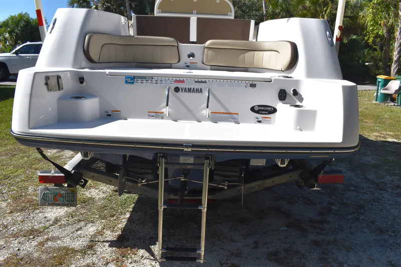 Slide: The Image of 2023 Yamaha Boats 252 FSH Sport interior with seating and storage compartments. - 9