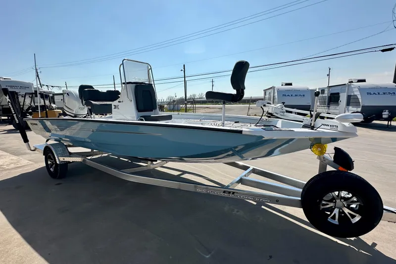 Slide: The Image of 2026 Express H20B boat on trailer, sleek design, parked outdoors under clear sky. - 2