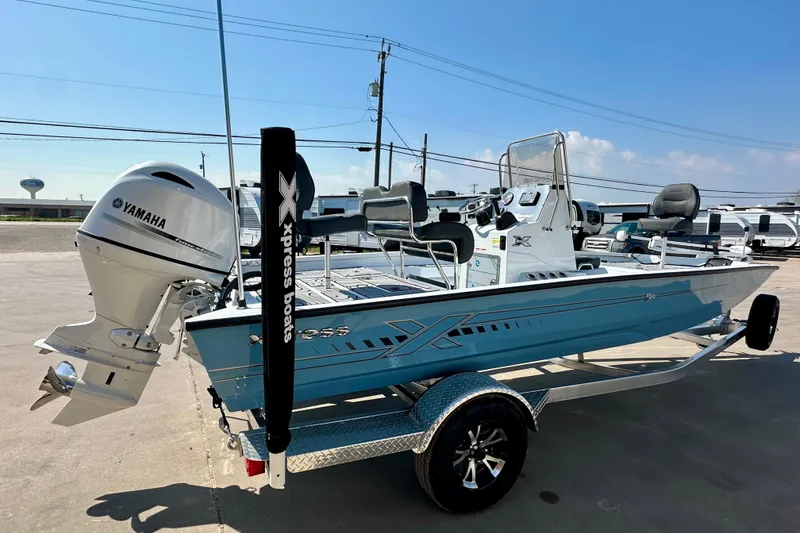 Slide: The Image of 2026 Express H20B boat with Yamaha engine on trailer, parked outdoors. - 3