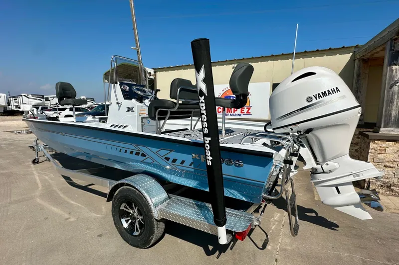 Slide: The Image of 2026 Express H20B boat with Yamaha motor on a trailer, parked outdoors. - 5