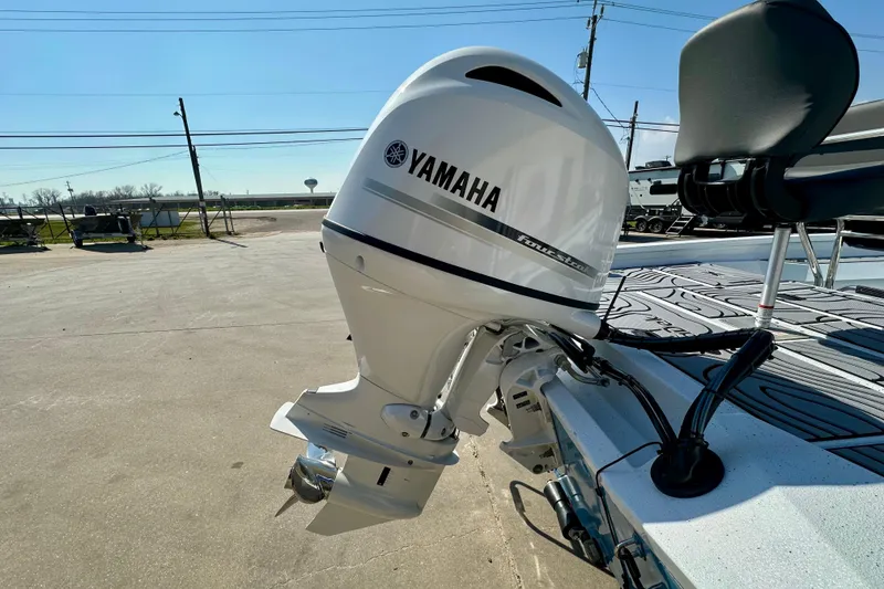 Slide: The Image of 2026 Express H20B boat with Yamaha outboard motor, parked outdoors on a sunny day. - 7