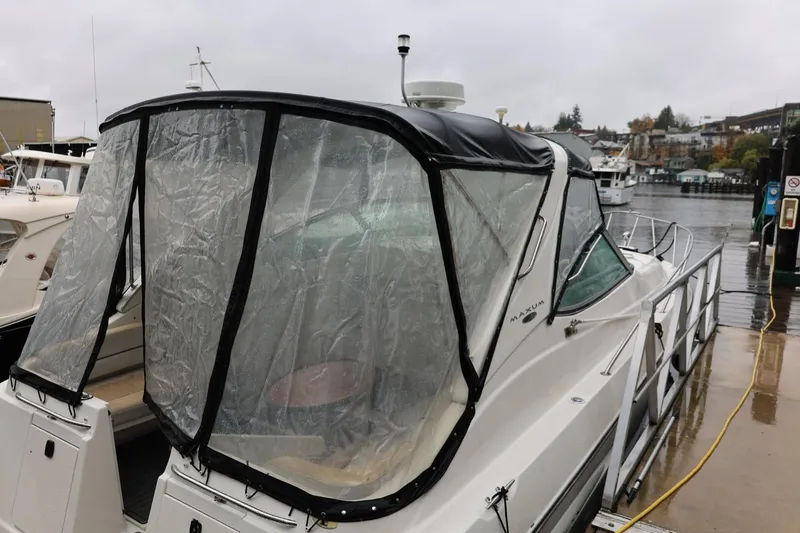 Slide: The Image of 2005 Maxum 3300 SE boat docked with rain cover on a cloudy day. - 14