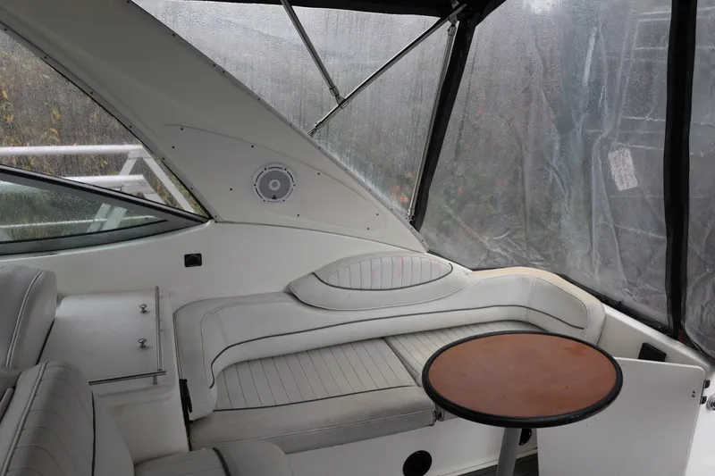 Slide: The Image of 2005 Maxum 3300 SE boat interior with seating and table, enclosed by clear panels. - 20