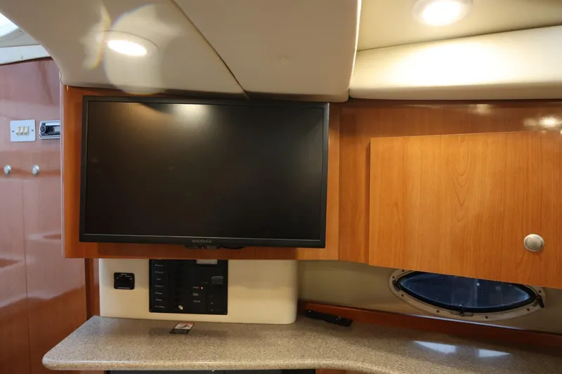 Slide: The Image of Interior of 2005 Maxum 3300 SE boat with TV and wooden cabinetry. - 23
