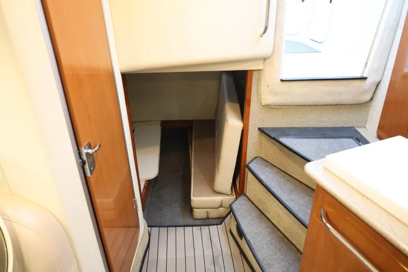 Slide: The Image of 2005 Maxum 3300 SE cabin interior with stairs and seating area. - 25