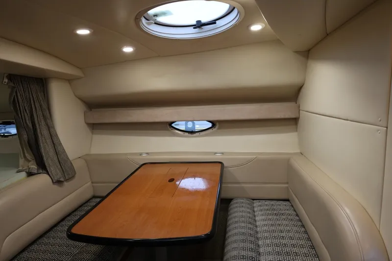Slide: The Image of 2005 Maxum 3300 SE cabin interior with dining area and porthole window. - 36