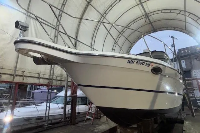Slide: The Image of 2005 Maxum 3300 SE boat in dry dock, under a protective canopy. - 42