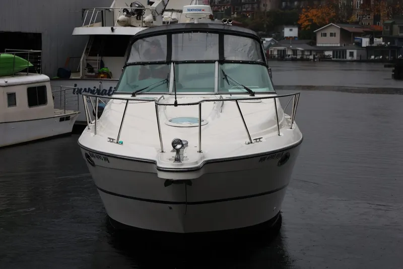 Slide: The Image of 2005 Maxum 3300 SE boat docked in a marina on a cloudy day. - 6