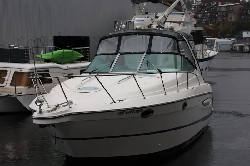 Slide: The Image of 2005 Maxum 3300 SE boat docked in a marina on a rainy day. - 7