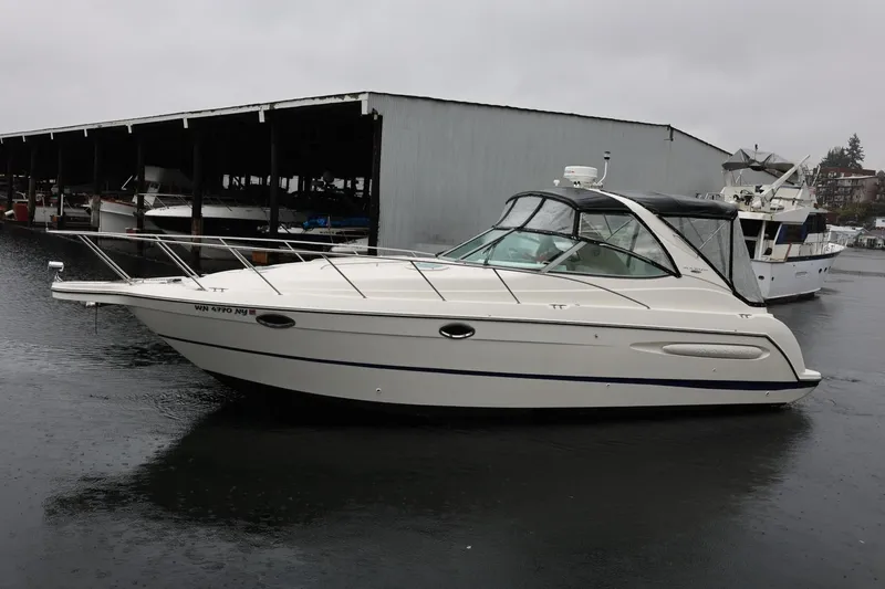Slide: The Image of 2005 Maxum 3300 SE boat docked in a marina on a rainy day. - 9