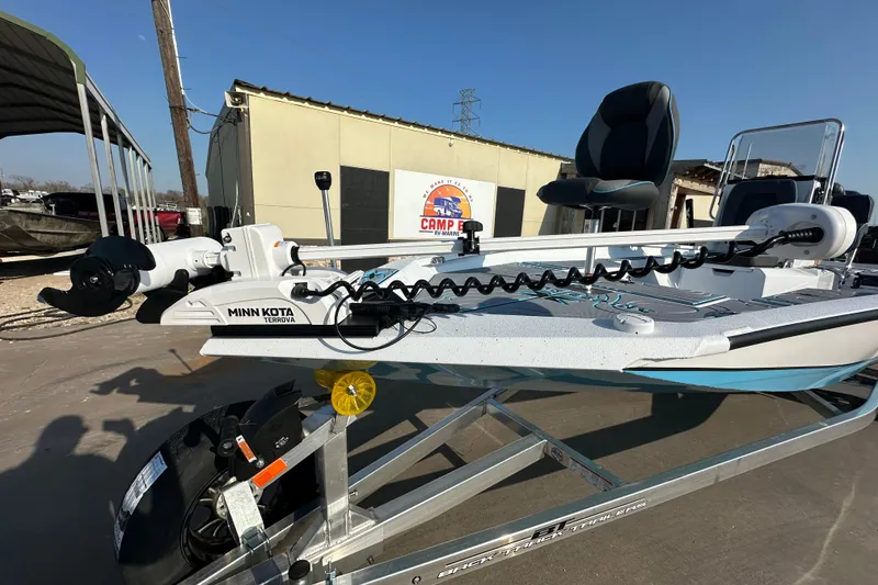 Slide: The Image of 2026 Express H22B boat with Minn Kota Terrova motor on trailer, outdoor setting. - 11