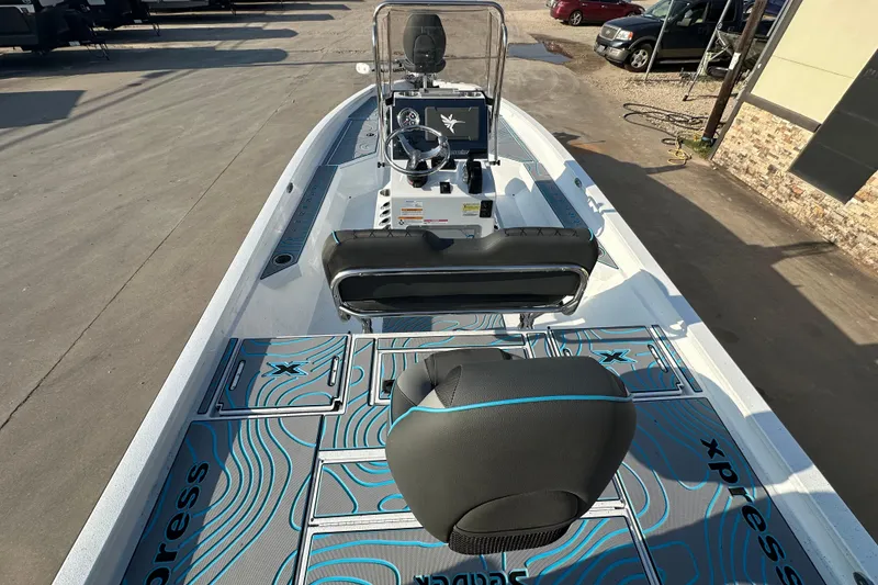 Slide: The Image of 2026 Express H22B boat interior with modern console and seating, featuring stylish blue accents. - 12