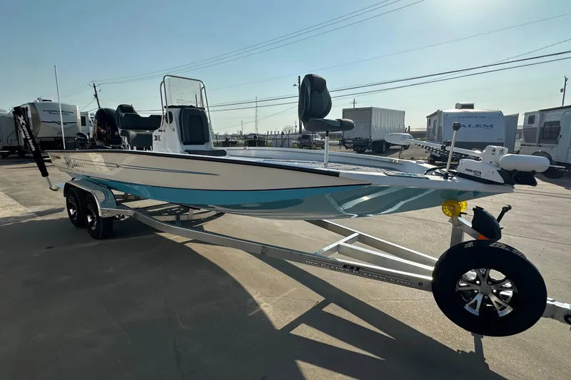 Slide: The Image of 2026 Express H22B boat on trailer, parked outdoors, showcasing sleek design and modern features. - 2