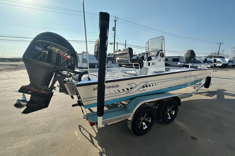 Slide: The Image of 2026 Express H22B boat with Yamaha engine on trailer, parked outdoors. - 3