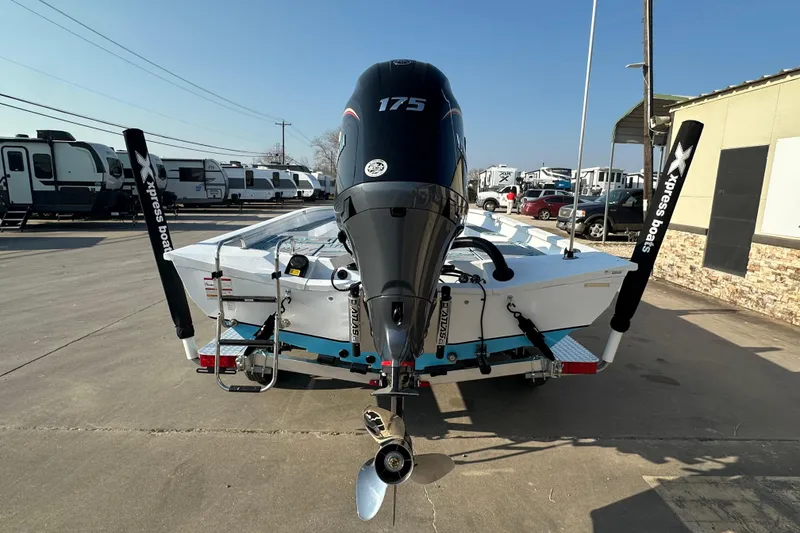 Slide: The Image of 2026 Express H22B boat with 175 horsepower engine, parked in a dealership lot. - 4