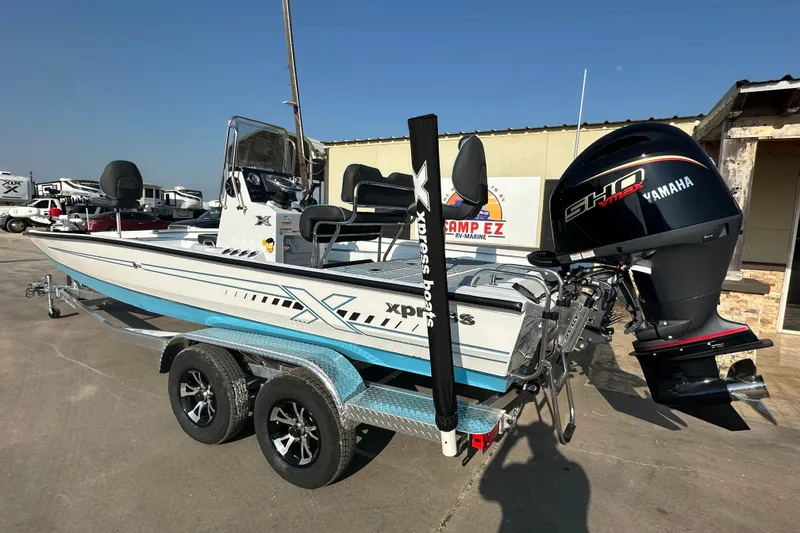 Slide: The Image of 2026 Express H22B boat with Yamaha engine on trailer, parked outdoors. - 5